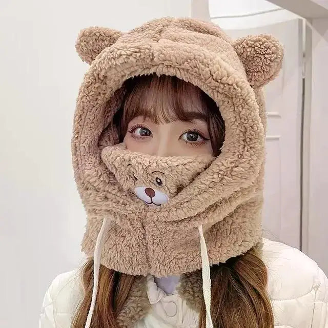 Person wearing a kawaii fluffy bear-themed hood and scarf on a plain background