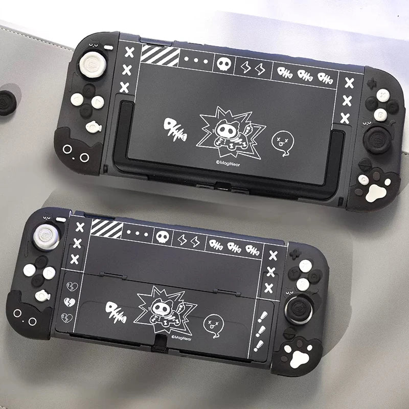Two black handheld gaming consoles with cartoon character design on a grey surface