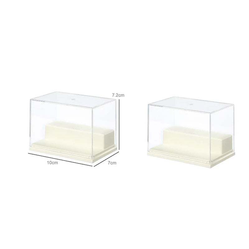 Two clear acrylic display boxes with cream-colored interior steps, shown on a white background. One box is labeled with dimensions 10cm, 7cm, and 7.