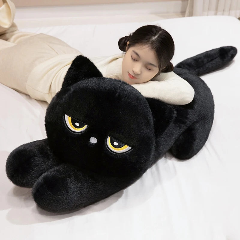 Woman sleeping on black Kawaii sleepy cat body pillow plushie