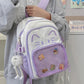 purple neko backpack displayed by person holding them.