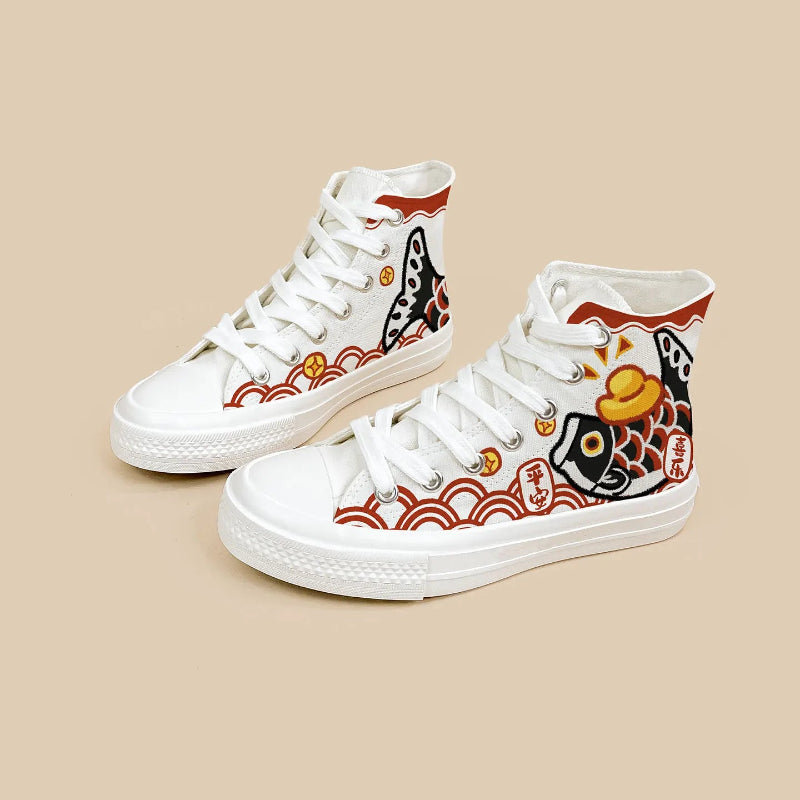 A pair of white high-top canvas sneakers with traditional Japanese koi fish and wave patterns in red, black, and gold, displayed on a solid beige background.