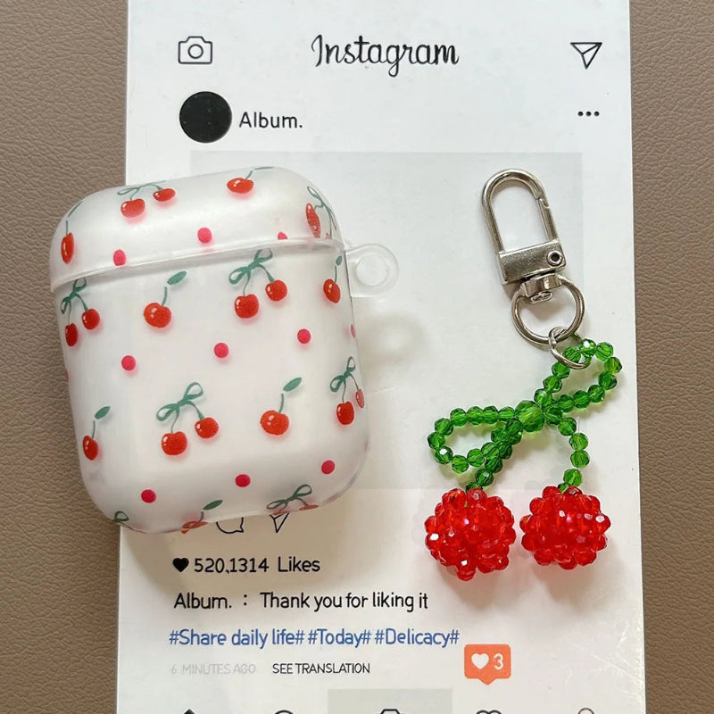 White air pod case with cherry pattern and cherry keychain