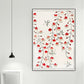Framed floral artwork with red flowers on a white wall