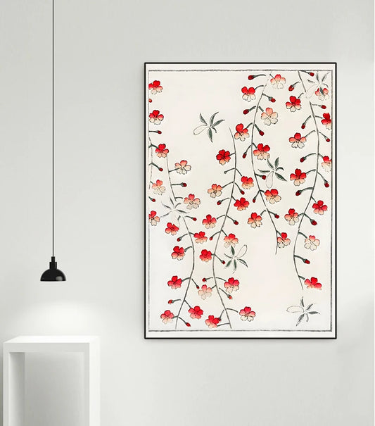 Framed floral artwork with red flowers on a white wall
