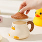 Hand holding lid of Kawaii Duck Mug with lid 
