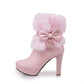 Pink high-heeled boot with fluffy top and bow detail on a white background