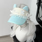 Visor hat with decorative elements on a mannequin head against a neutral background