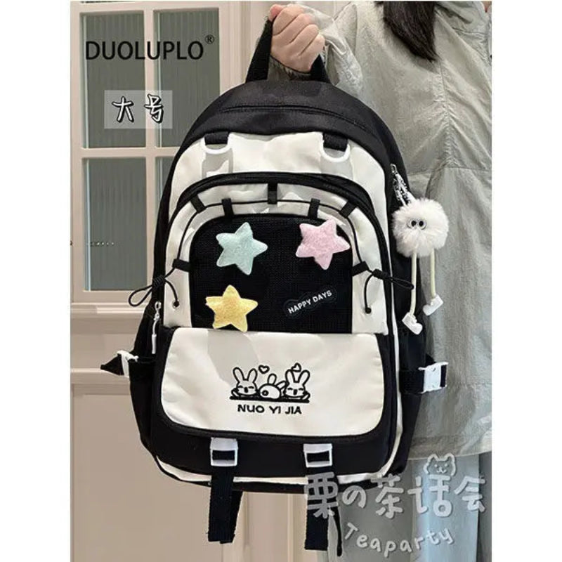 Kawaii backpack with star designs being held by a person