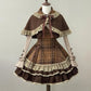 Brown and beige plaid dress with lace details on a mannequin against a plain background