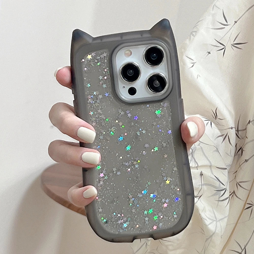 Phone case with star glitter design held by a hand against a neutral background