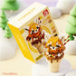 kawaii ice cream building block animal red panda edition displayed on a snowy background along side its box.