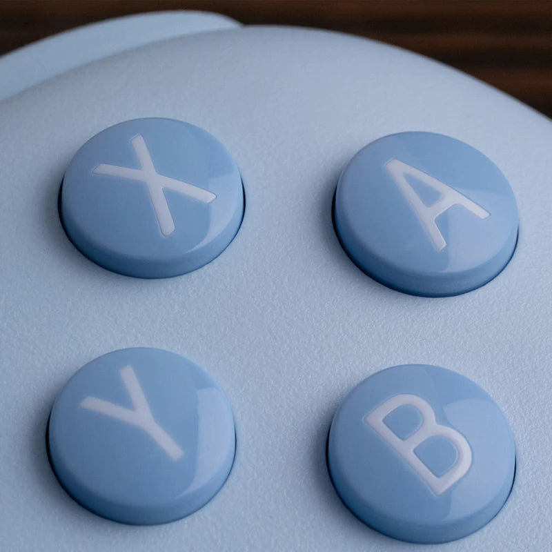 Close-up of blue buttons labeled 'X', 'A', 'Y', and 'B' on a gaming controller.