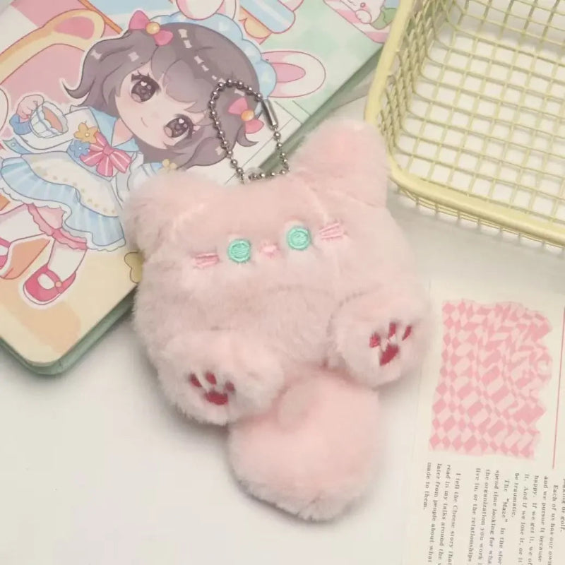 Pink plush keychain with cartoon character on a surface