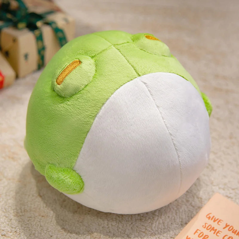 Kawaii green and white frog plushie on carpet 