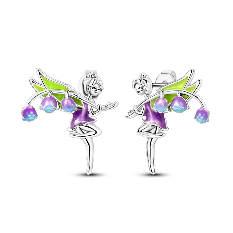 Fairy-themed earrings with green wings and purple bodies on a white background
