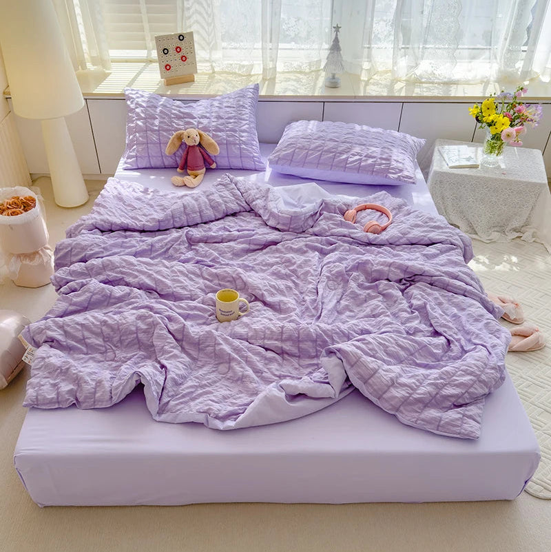 Purple  seersucker duvet set displayed on bed.