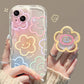 A woman is holding one of the designs for the Kawaii Cherry Blossom Samsung Phone Case, this is the chunky drawn flower design case with phone grip that attaches to it.