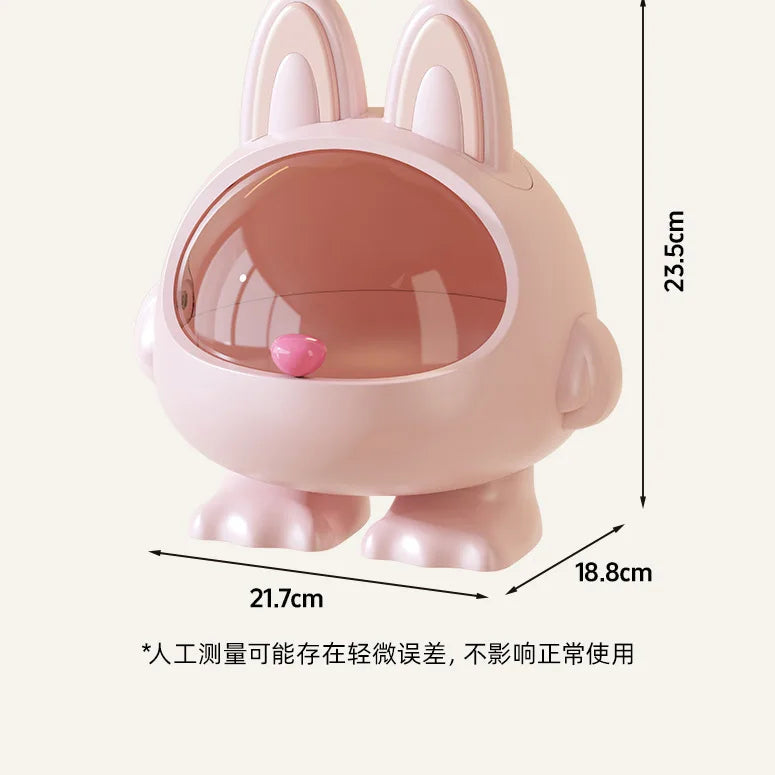 A pink bunny-shaped container or dispenser with a transparent oval window and small feet, shown with dimension lines and measurements: 23.5 cm height, 21.