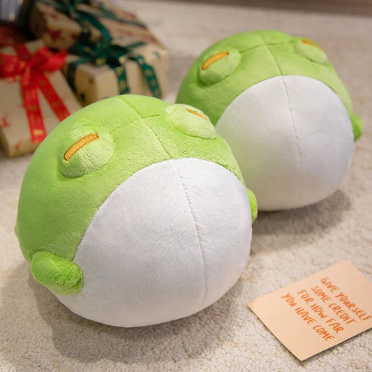 Two round Kawaii frog plushies on carpet