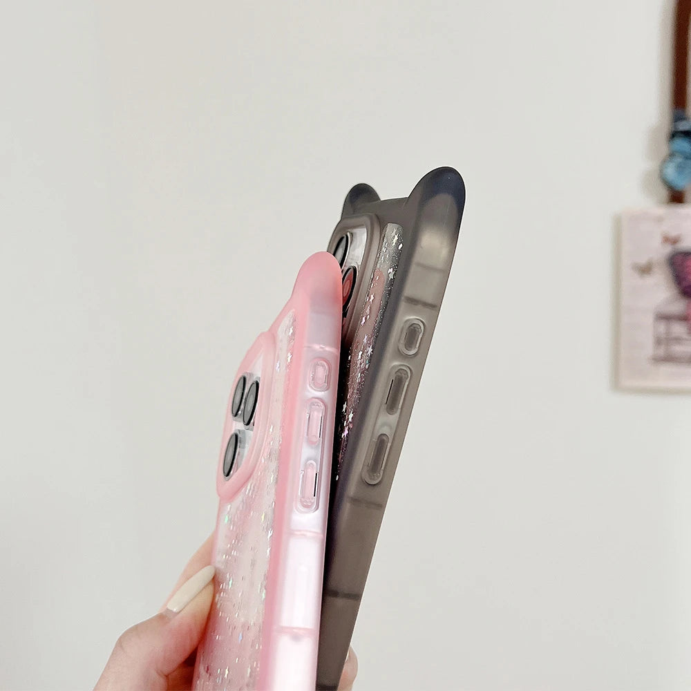 Two phone cases, one pink and one black, held against a plain background.