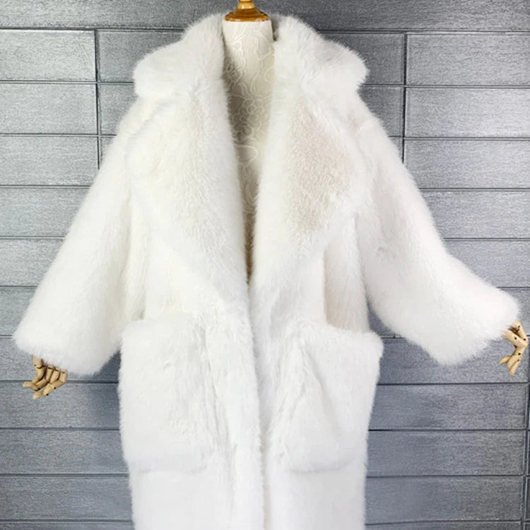 White fur coat on a wooden hanger against a gray tiled wall.