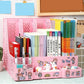 Pink stationery organizer with books and stationery items on a tiled floor.