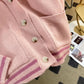 Sweet Teddy Bear Cardigan pastel pink edition with a bear sown into the chest area whilst the sleeves have large black stitches where they have been joined and black strips on the wrist cuffs and black and pink trim, this image is displaying the buttons and the lower trim design.