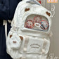 beary cute backpack with bear ears and a visible brand logo on a persons back, white version