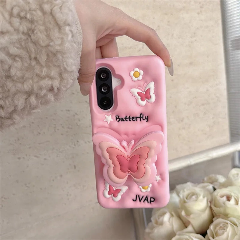This image is showing  Kawaii Butterfly Samsung Phone Case, one option is the pink design with a large 3D butterfly in the middle which is a phone grip with smaller butterflies around it and some white flowers.