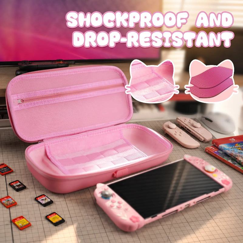 Pink gaming console case with cat ears on a grid surface, surrounded by gaming accessories.