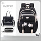 Black backpack with star designs and matching handbag on a light gray background, branded 'CUTESY'.