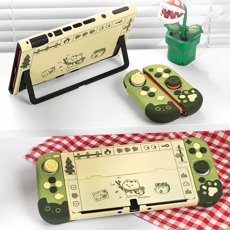 Two views of a green gaming console with cartoon designs on a white background.