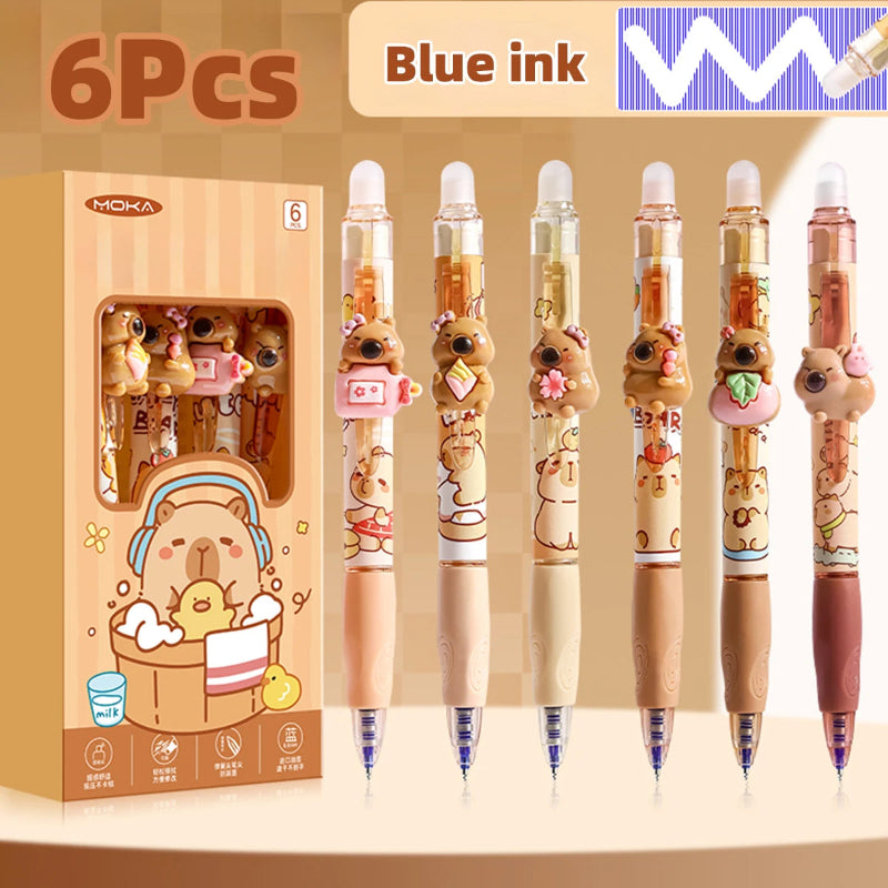 Set of six kawaii capybara pens with blue ink, displayed in front of their packaging.