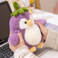Front view of Kawaii Cute Penguin Eggplant Plushie held by a woman on a desk