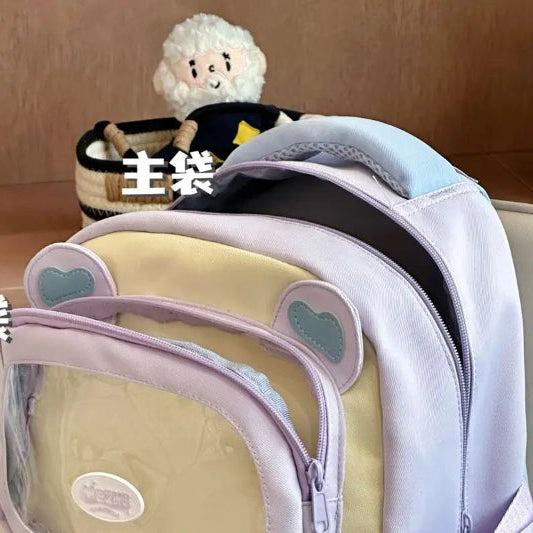 beary cute backpack with bear ears is being shown open at the top to show off storage and the zips