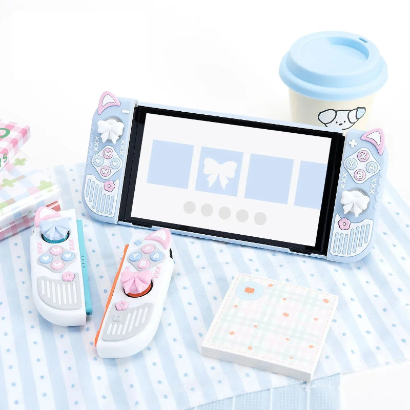 Nintendo Switch console with screen, remote controls, and stationery on a polka dot surface