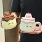 Two Kawaii Animal Pudding Ceramic Mugs being held by a person in a black t-shirt
