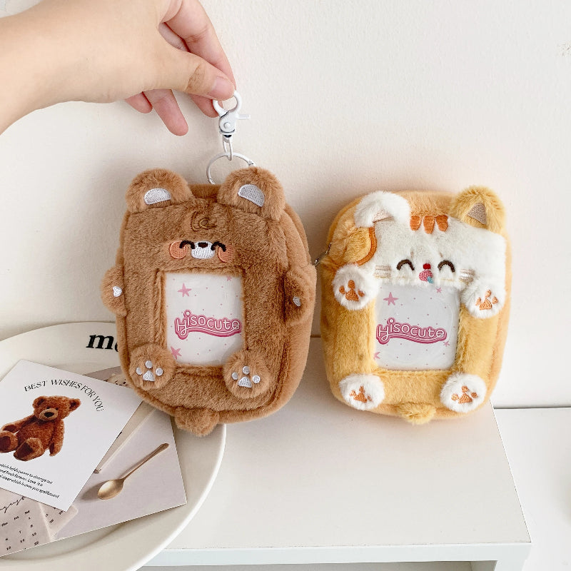 Two plush keychains with cartoon designs on a white surface.