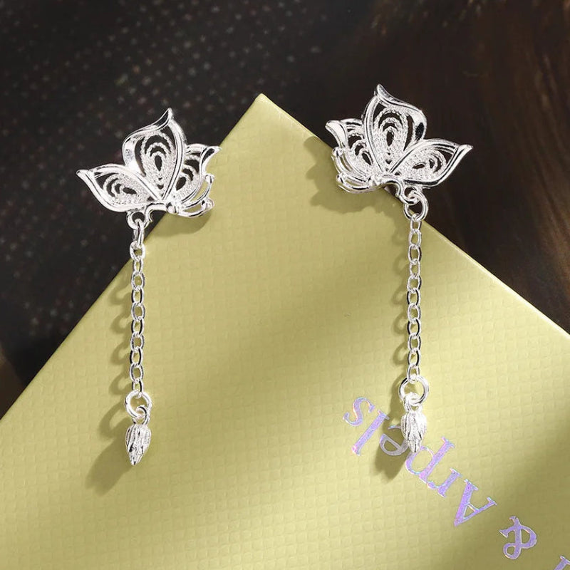 Kawaii Silver Butterfly Stud Earrings displayed on a table 