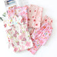 Set of pink floral pajama pants on a white background
