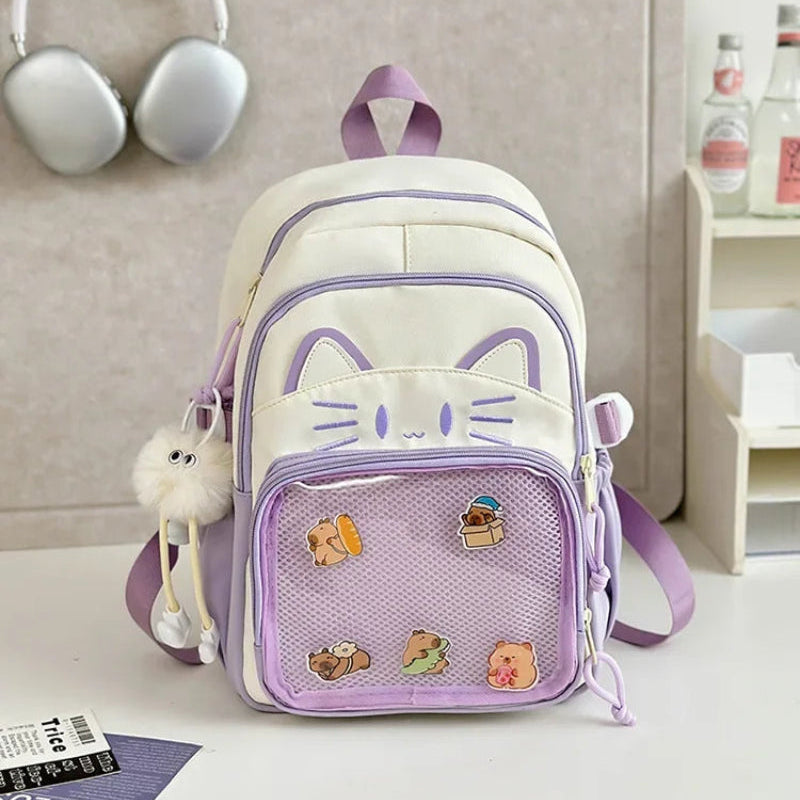 purple neko backpack displayed by person holding them.