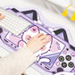 Person using a keyboard on a decorative desk mat with kawaii character design