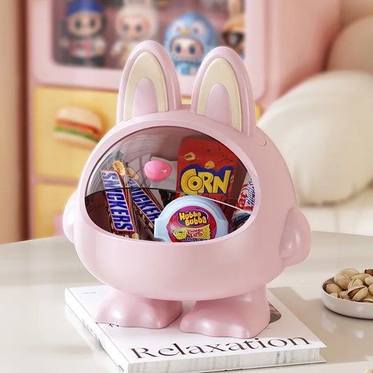 Pink bunny-shaped container with snacks on a magazine