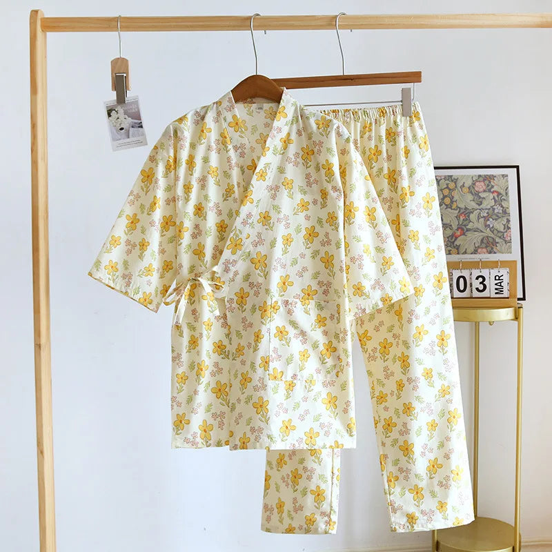 Floral pajama set hanging on a wooden rack against a white wall.