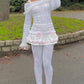 Front view of a Kawaii Coquette Off Shoulder Ribbon Sweater modeled by a woman in white