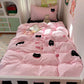 A pink quilted bedding set with black cat embroidery and bows, styled on a white single bed in a child's bedroom.