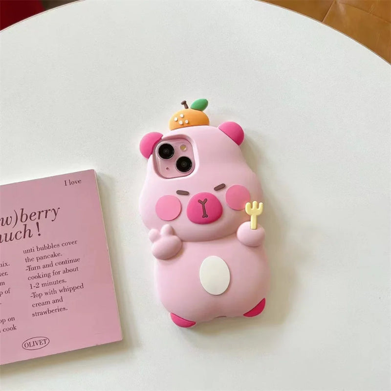 Pink capybara phone case on a white surface with a pink book next to it.