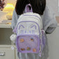 purple neko backpack displayed by person holding them.