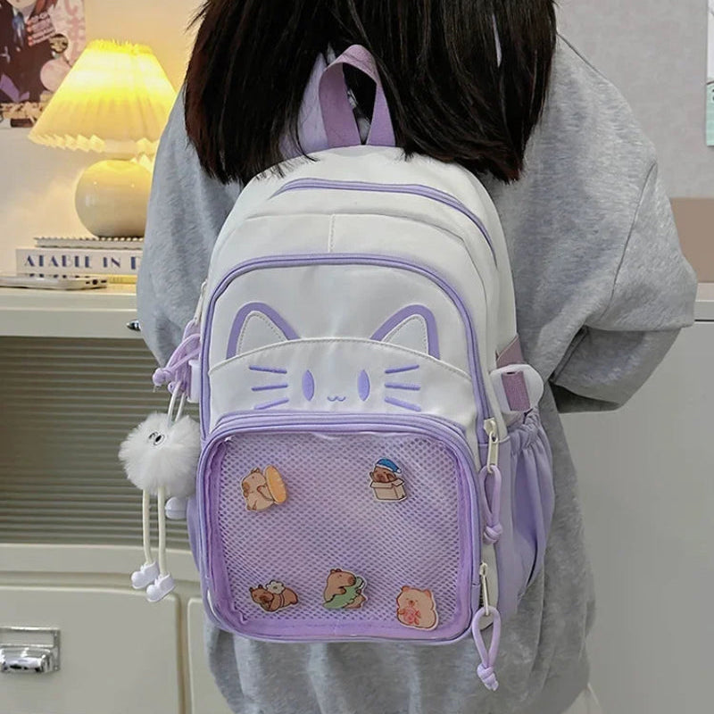 purple neko backpack displayed by person holding them.